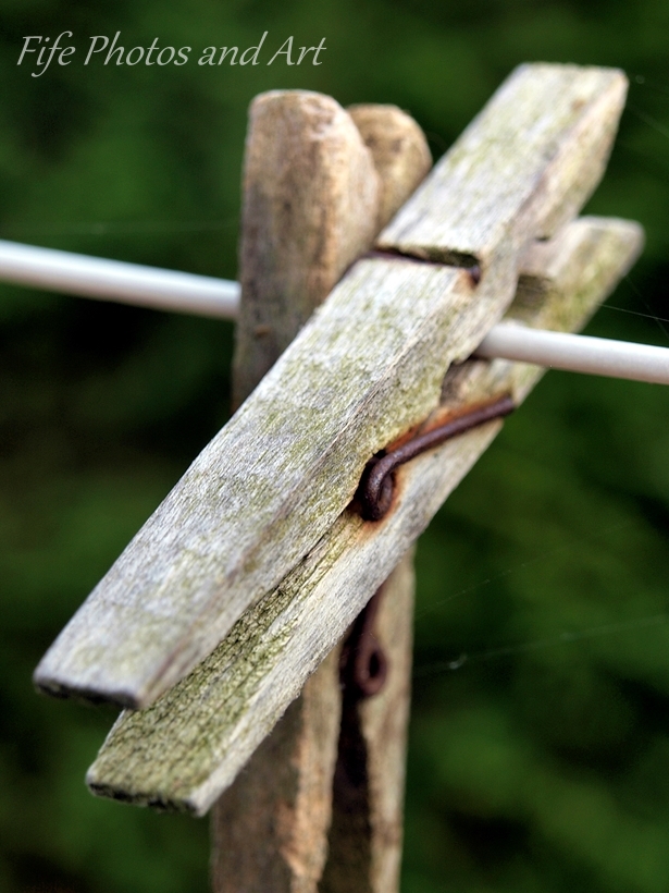 Two wooden pegs on a washing line