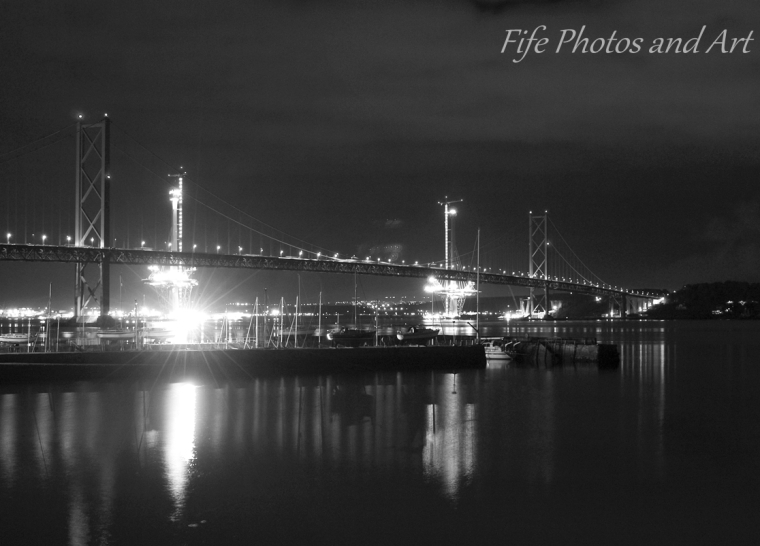 Forth Road Bridge at night from South Queensferrry, with harbour in foreground